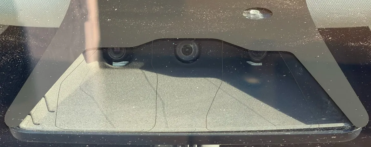 HW3 front camera cluster showing three identical black lenses